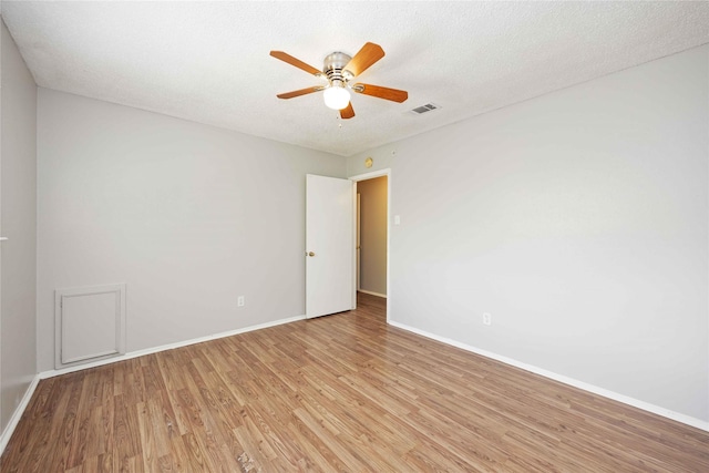 11750 Murr Way, Houston, TX 77048 - unfurnished room featuring light wood-style flooring, baseboards, a ceiling fan, and a textured ceiling