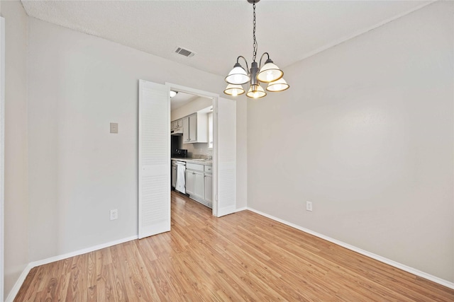 11750 Murr Way, Houston, TX 77048 - unfurnished room with baseboards, a chandelier, and light wood finished floors