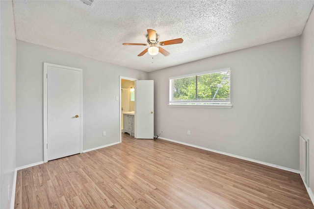 11750 Murr Way, Houston, TX 77048 - unfurnished bedroom featuring a textured ceiling, light wood-type flooring, baseboards, ensuite bathroom, and ceiling fan
