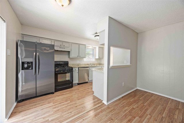11750 Murr Way, Houston, TX 77048 - kitchen with appliances with stainless steel finishes, light wood-type flooring, gray cabinets, baseboards, and a textured ceiling