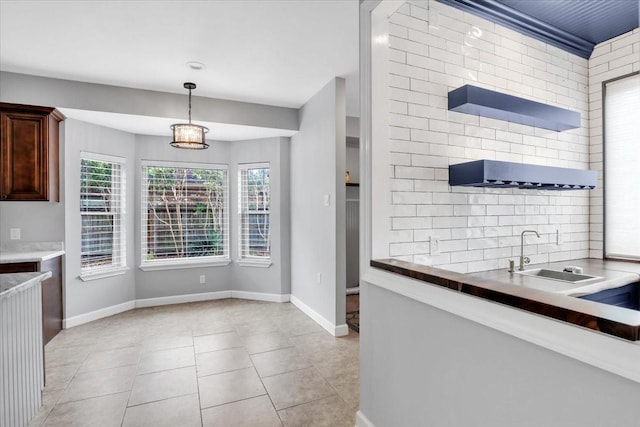 12151 Maple Rock Dr, Houston, TX 77077 - kitchen with a sink, light tile patterned floors, pendant lighting, and baseboards
