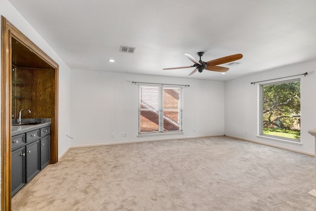 12151 Maple Rock Dr, Houston, TX 77077 - spare room featuring a sink, plenty of natural light, a ceiling fan, light carpet, and recessed lighting