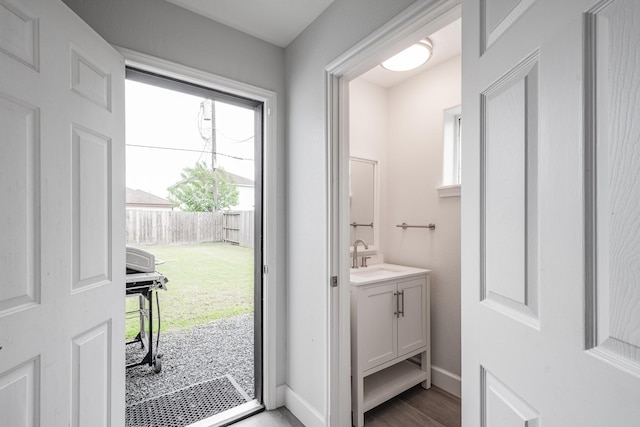 9026 Mcgallion Rd, Houston, TX 77022 - bathroom featuring vanity, wood finished floors, and baseboards