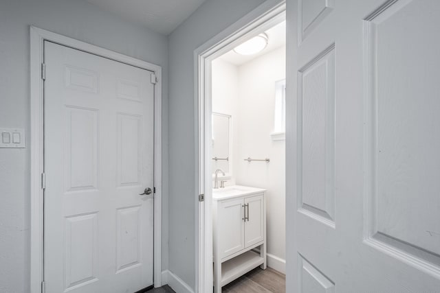 9026 Mcgallion Rd, Houston, TX 77022 - bathroom featuring vanity, wood finished floors, and baseboards