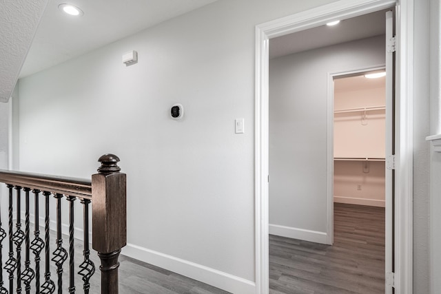 9026 Mcgallion Rd, Houston, TX 77022 - corridor with wood finished floors, baseboards, recessed lighting, and an upstairs landing