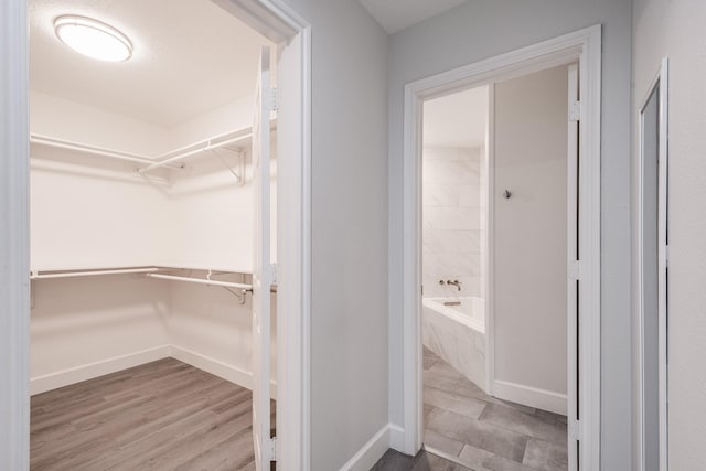 9026 Mcgallion Rd, Houston, TX 77022 - walk in closet featuring wood finished floors