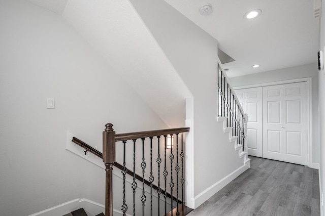 9026 Mcgallion Rd, Houston, TX 77022 - staircase with recessed lighting, baseboards, and wood finished floors