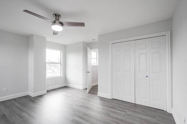 9026 Mcgallion Rd, Houston, TX 77022 - unfurnished bedroom featuring wood finished floors, a closet, baseboards, and a ceiling fan