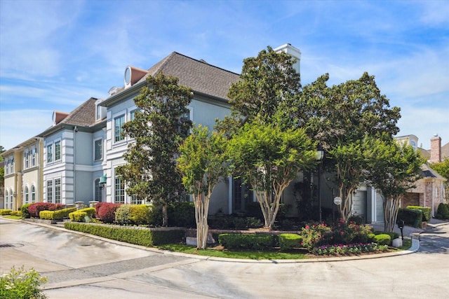 1 Exbury Way, Houston, TX 77056 - view of side of property featuring stucco siding and a chimney