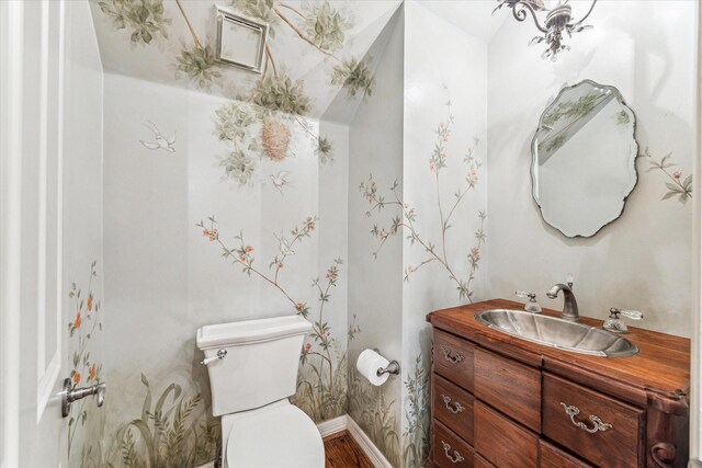 1 Exbury Way, Houston, TX 77056 - half bath featuring toilet, vanity, wood finished floors, and baseboards