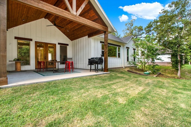 6114 E Bluff Ct, Magnolia, TX 77354 - rear view of property with board and batten siding, french doors, a lawn, and a patio area