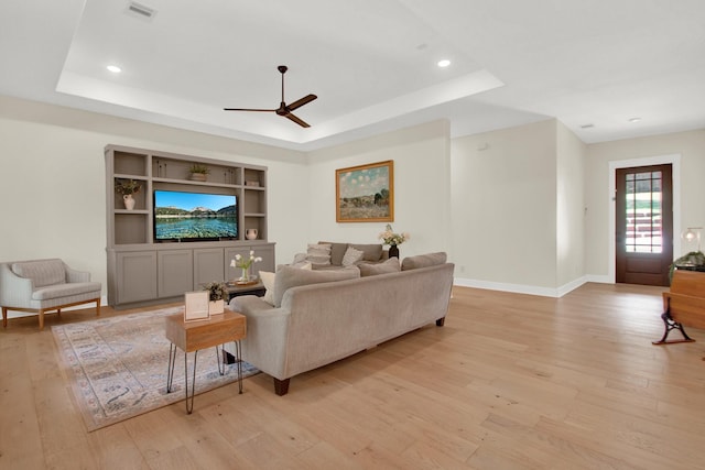 6114 E Bluff Ct, Magnolia, TX 77354 - living area featuring light wood-style flooring, a ceiling fan, a tray ceiling, and recessed lighting