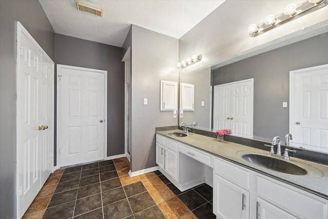 19119 Timber Trace Dr, Humble, TX 77346 - bathroom with double vanity, baseboards, and tile patterned floors