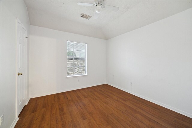 19119 Timber Trace Dr, Humble, TX 77346 - empty room with dark wood-style flooring, baseboards, a ceiling fan, and vaulted ceiling