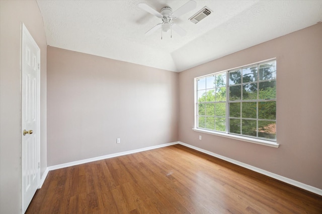 19119 Timber Trace Dr, Humble, TX 77346 - spare room with wood finished floors, baseboards, ceiling fan, and lofted ceiling