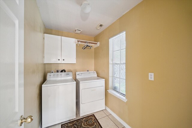 19119 Timber Trace Dr, Humble, TX 77346 - washroom with washer and clothes dryer, cabinet space, light tile patterned floors, and baseboards