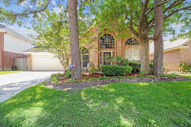 19119 Timber Trace Dr, Humble, TX 77346 - traditional-style house with brick siding, a front yard, driveway, and a garage