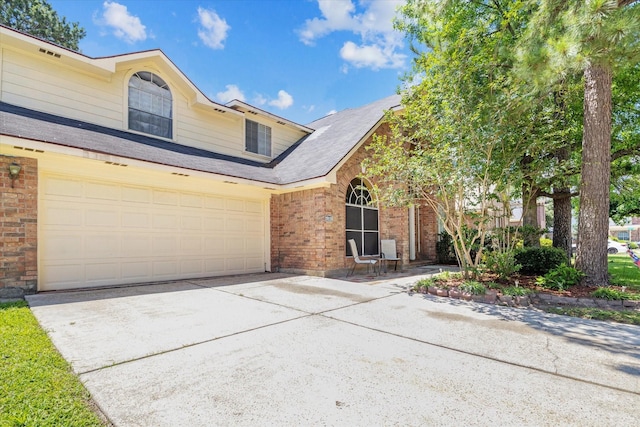 19119 Timber Trace Dr, Humble, TX 77346 - traditional-style house featuring brick siding, driveway, and an attached garage