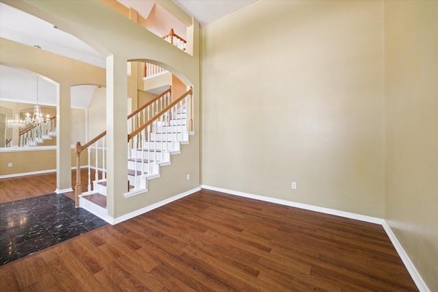 19119 Timber Trace Dr, Humble, TX 77346 - foyer featuring stairway, wood finished floors, baseboards, a chandelier, and arched walkways