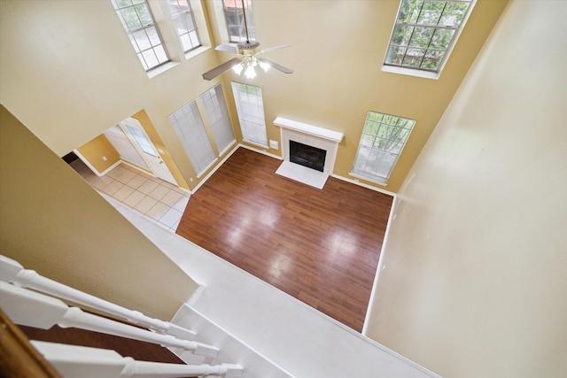 19119 Timber Trace Dr, Humble, TX 77346 - entryway with healthy amount of natural light, a high ceiling, ceiling fan, a fireplace with flush hearth, and wood finished floors