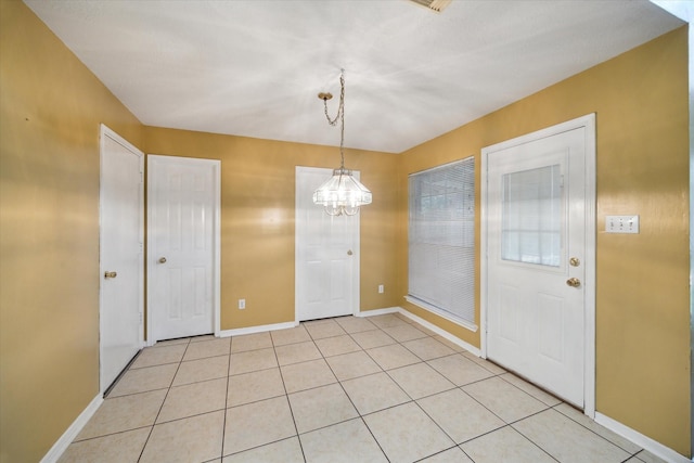 19119 Timber Trace Dr, Humble, TX 77346 - unfurnished dining area with a chandelier, baseboards, and light tile patterned floors