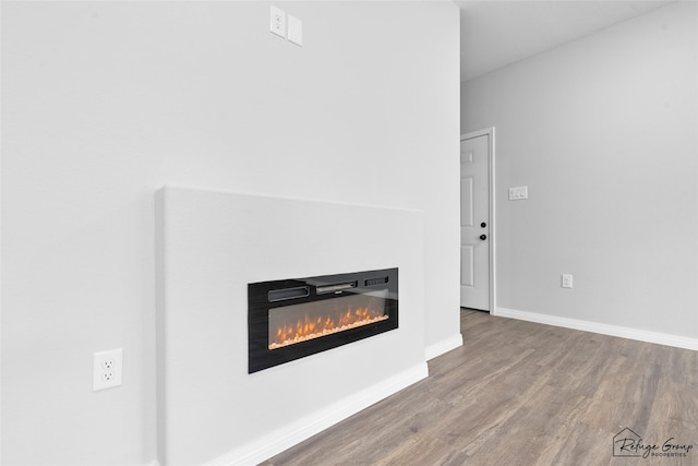 7983 Ethel St, Houston, TX 77028 - detailed view of a glass covered fireplace, wood finished floors, and baseboards