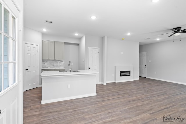 7983 Ethel St, Houston, TX 77028 - kitchen with gray cabinets, a sink, tasteful backsplash, open floor plan, and recessed lighting