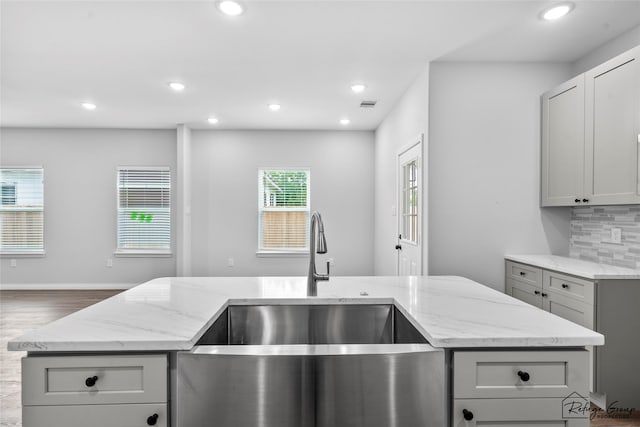 7983 Ethel St, Houston, TX 77028 - kitchen featuring a sink, light stone countertops, backsplash, recessed lighting, and gray cabinets