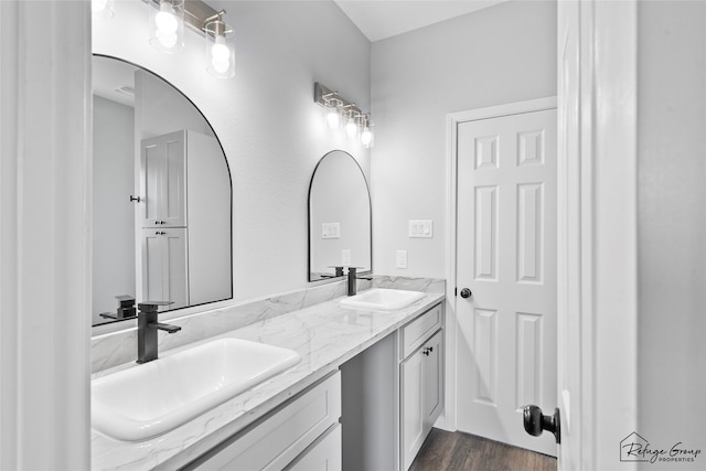 7983 Ethel St, Houston, TX 77028 - bathroom with double vanity and wood finished floors