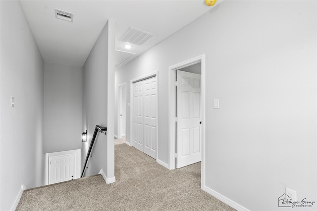 7983 Ethel St, Houston, TX 77028 - corridor featuring an upstairs landing, carpet floors, baseboards, and attic access