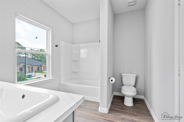 7983 Ethel St, Houston, TX 77028 - full bathroom featuring a sink, wood finished floors, toilet, baseboards, and  shower combination