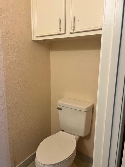 7847 Creekbend Dr, Houston, TX 77071 - bathroom featuring baseboards, toilet, and tile patterned floors