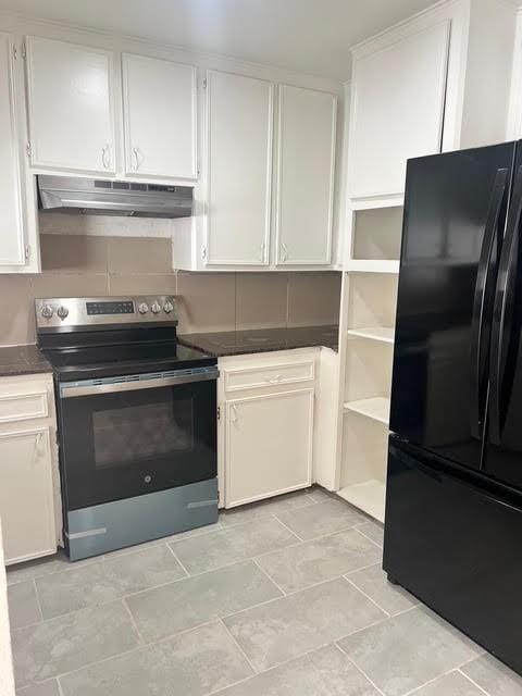 7847 Creekbend Dr, Houston, TX 77071 - kitchen with freestanding refrigerator, stainless steel electric range oven, under cabinet range hood, dark countertops, and white cabinetry