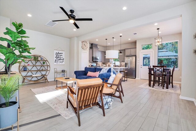 477 Long Leaf Pine Dr, Montgomery, TX 77316 - living room featuring recessed lighting, light wood-style flooring, ceiling fan, baseboards, and a chandelier