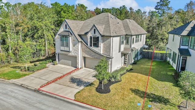 477 Long Leaf Pine Dr, Montgomery, TX 77316 - view of front of home with an attached garage, concrete driveway, stone siding, roof with shingles, and view of wooded area