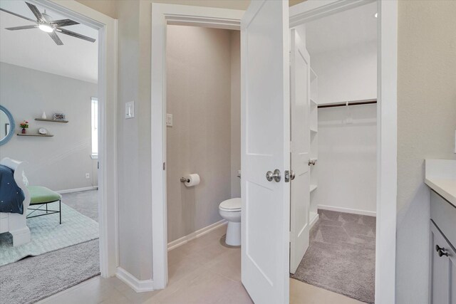 477 Long Leaf Pine Dr, Montgomery, TX 77316 - full bath with toilet, a ceiling fan, vanity, a walk in closet, and baseboards