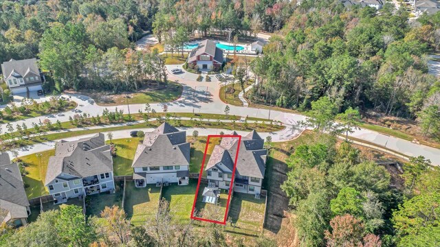 477 Long Leaf Pine Dr, Montgomery, TX 77316 - aerial overview of property's location with property parcel outlined, a pool, and nearby suburban area