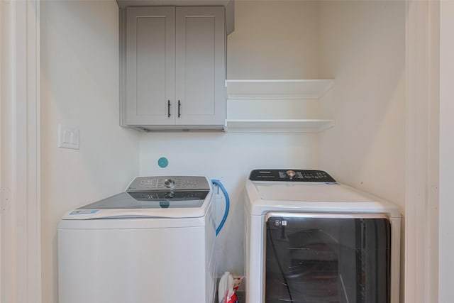 2909 Nagle St, Houston, TX 77004 - clothes washing area featuring washing machine and dryer and cabinet space