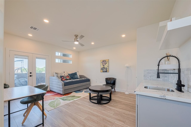 2909 Nagle St, Houston, TX 77004 - living room with french doors, light wood-style floors, ceiling fan, recessed lighting, and baseboards