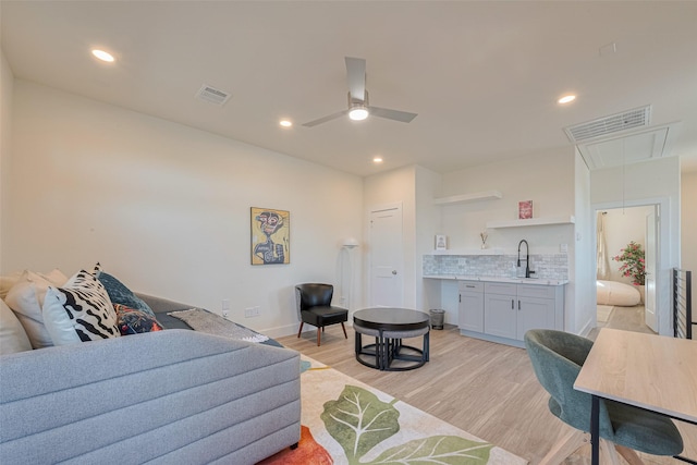 2909 Nagle St, Houston, TX 77004 - living area featuring light wood finished floors, attic access, bar with sink, recessed lighting, and a ceiling fan