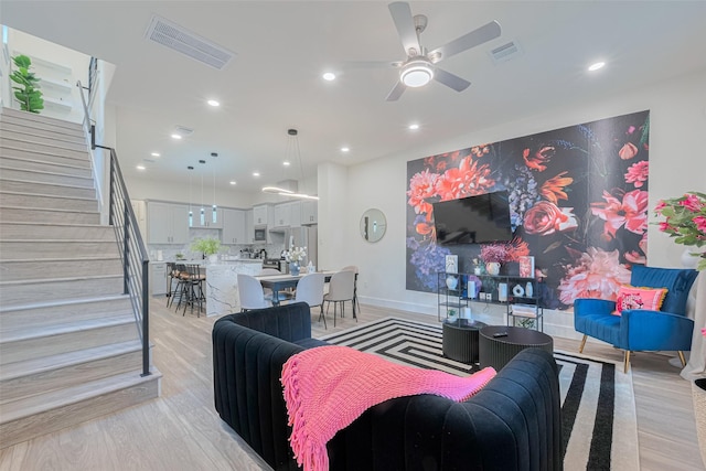 2909 Nagle St, Houston, TX 77004 - living room featuring stairs, a ceiling fan, recessed lighting, light wood-type flooring, and baseboards