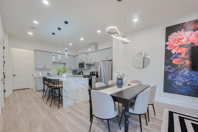 2909 Nagle St, Houston, TX 77004 - dining room with light wood-type flooring, recessed lighting, and baseboards