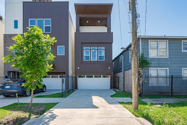 2909 Nagle St, Houston, TX 77004 - view of front of house featuring driveway, a garage, fence, and stucco siding