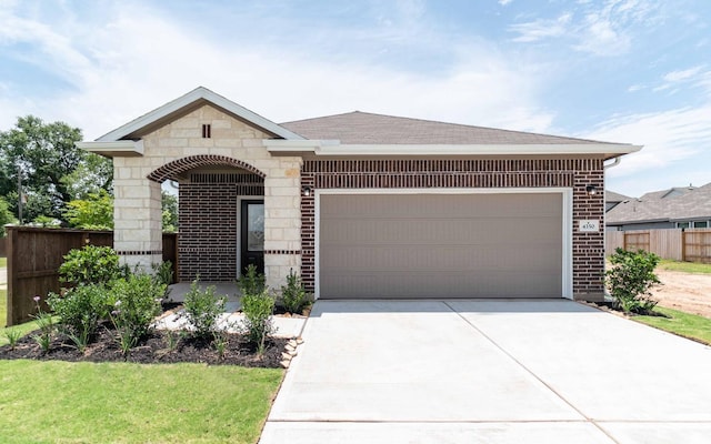 4350 Maple Root Ln, Pinehurst, TX 77362 - french country style house featuring brick siding, driveway, an attached garage, stone siding, and roof with shingles