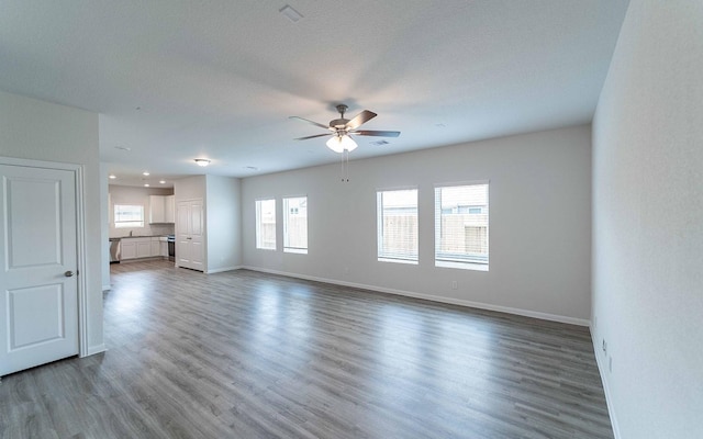 4350 Maple Root Ln, Pinehurst, TX 77362 - unfurnished living room featuring ceiling fan, wood finished floors, and recessed lighting