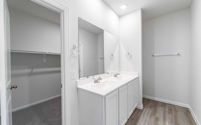 4350 Maple Root Ln, Pinehurst, TX 77362 - bathroom featuring double vanity and wood finished floors
