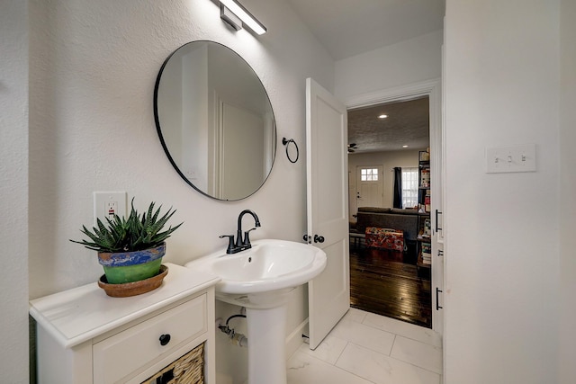 5120 Leeland St, Houston, TX 77023 - bathroom with marble look tile flooring, recessed lighting, and a sink