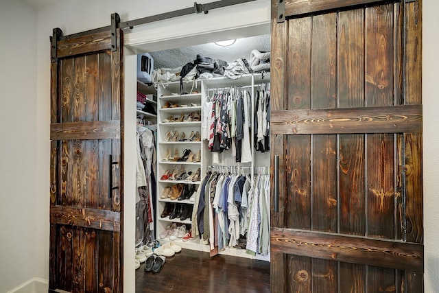 5120 Leeland St, Houston, TX 77023 - walk in closet featuring a barn door and wood finished floors