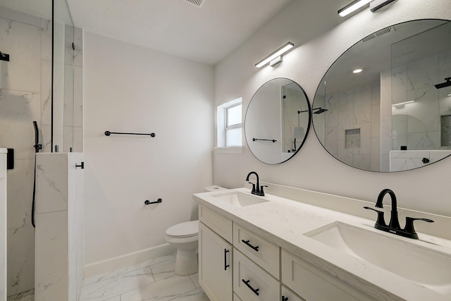 5120 Leeland St, Houston, TX 77023 - bathroom with marble look tile flooring, a marble finish shower, double vanity, toilet, and baseboards