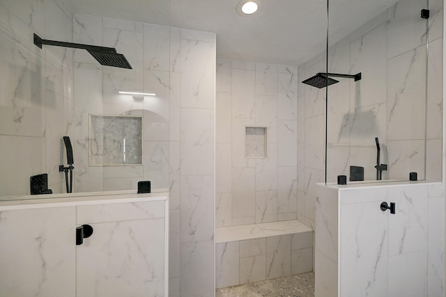 5120 Leeland St, Houston, TX 77023 - bathroom with a marble finish shower, recessed lighting, and tile walls